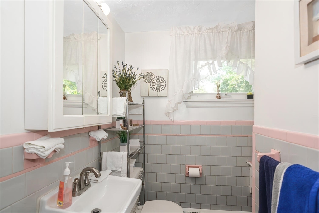 9 Flagg Drive Framingham, MA 01702 - Photo 8 of 22 a bathroom with a sink a toilet and a mirror