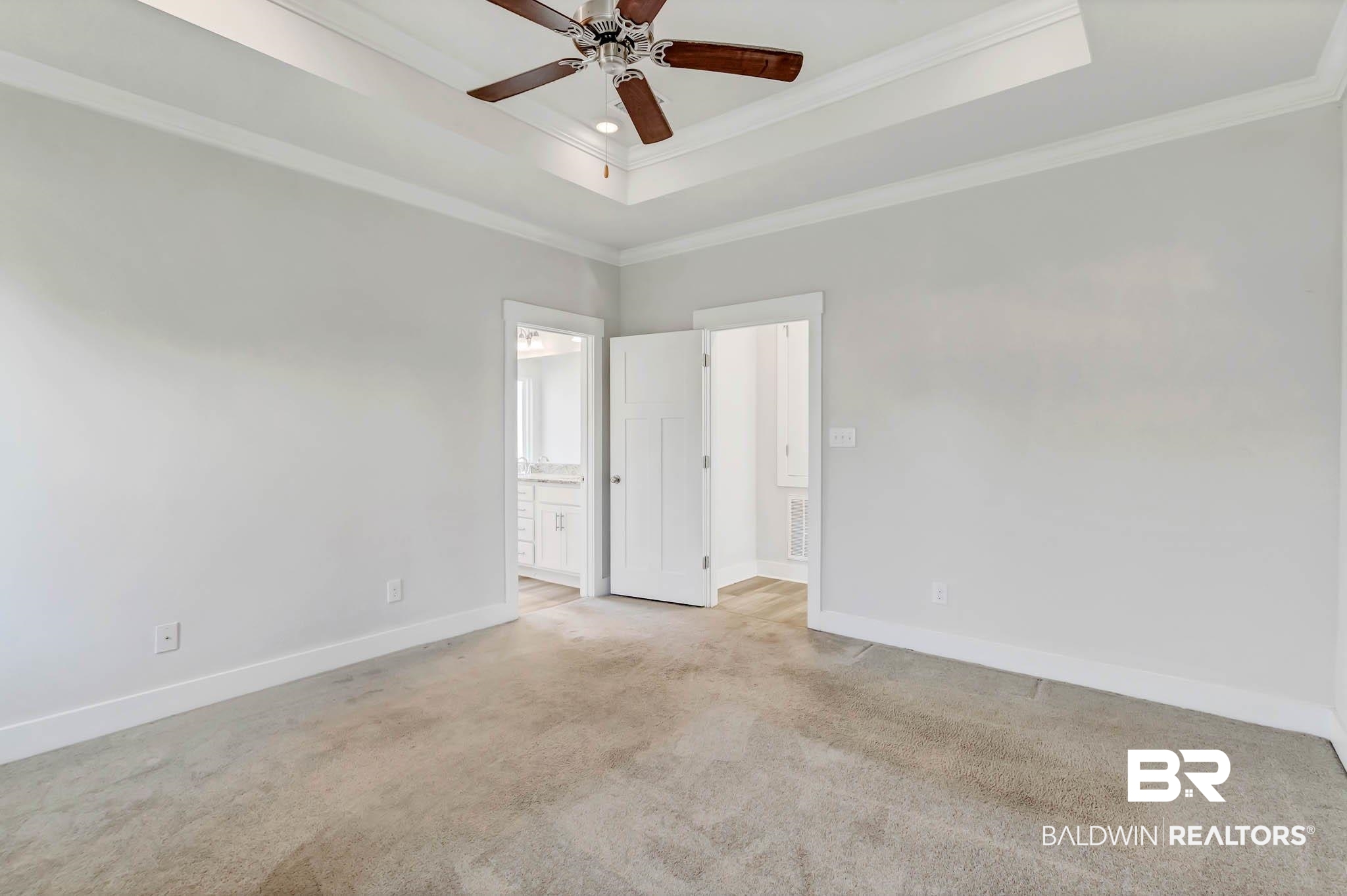 16461 Prado Loop Loxley, AL 36551 - Photo 43 of 78 Carpeted empty room featuring a tray ceiling, crown molding, and ceiling fan