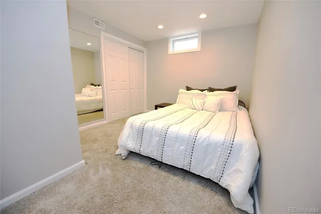 a bedroom with a bed and cabinets