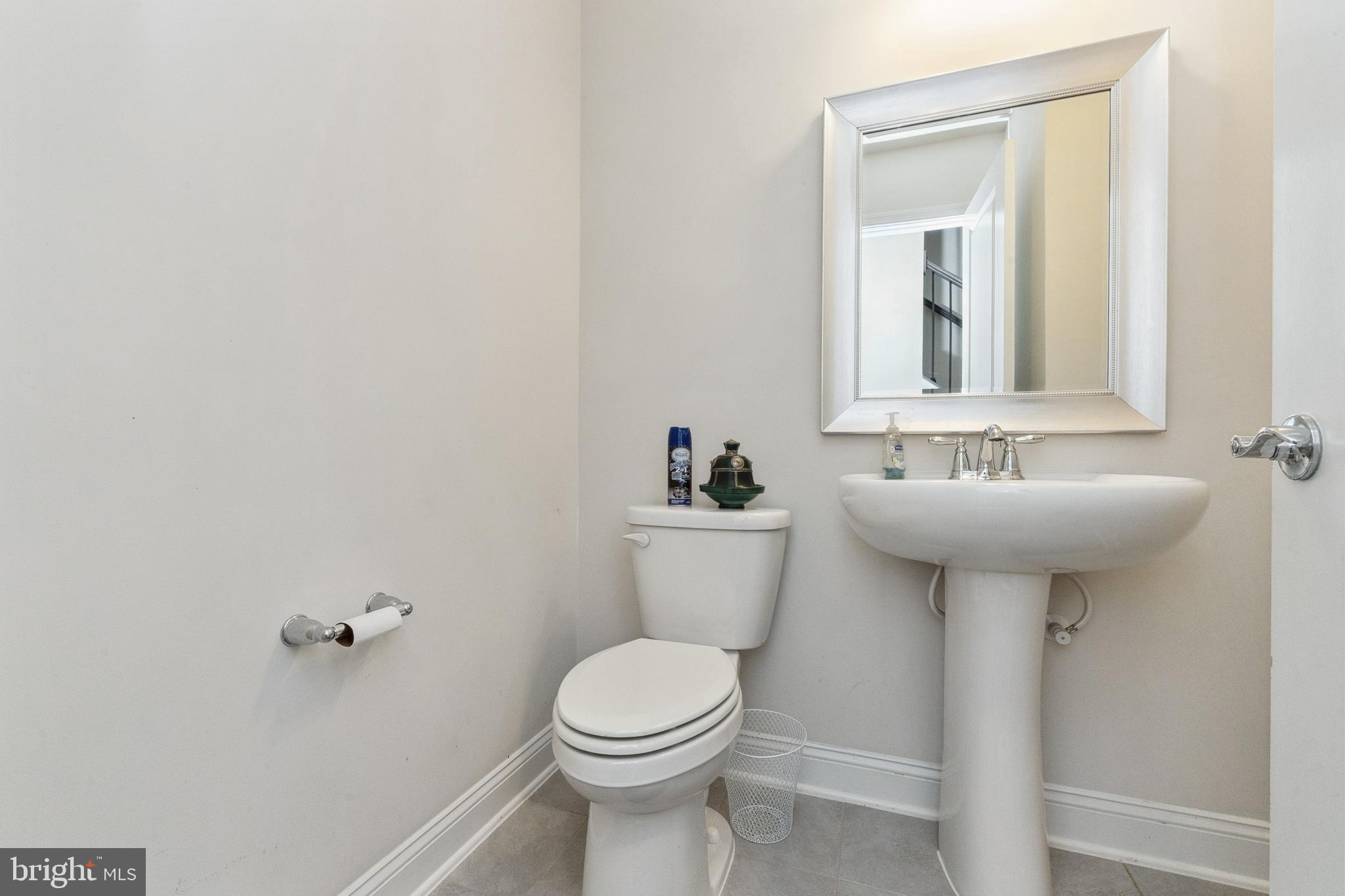 1925 Greenbriar Hall Road Dumfries, VA 22026 - Photo 7 of 63 a bathroom with a sink a toilet and mirror