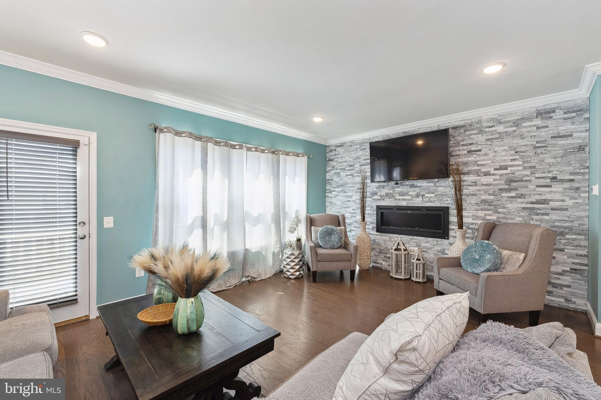 1925 Greenbriar Hall Road Dumfries, VA 22026 - Photo 10 of 63 a living room with furniture a flat screen tv and a fireplace