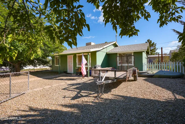a view of a house with backyard sitting area and porch