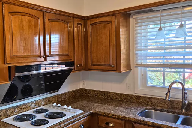 a kitchen with a sink and a stove
