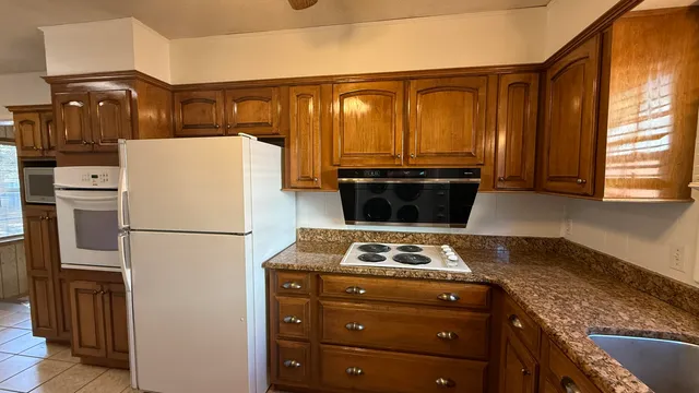 a refrigerator freezer sitting inside of a kitchen