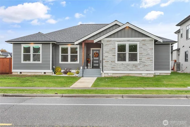 a front view of a house with a garden and yard