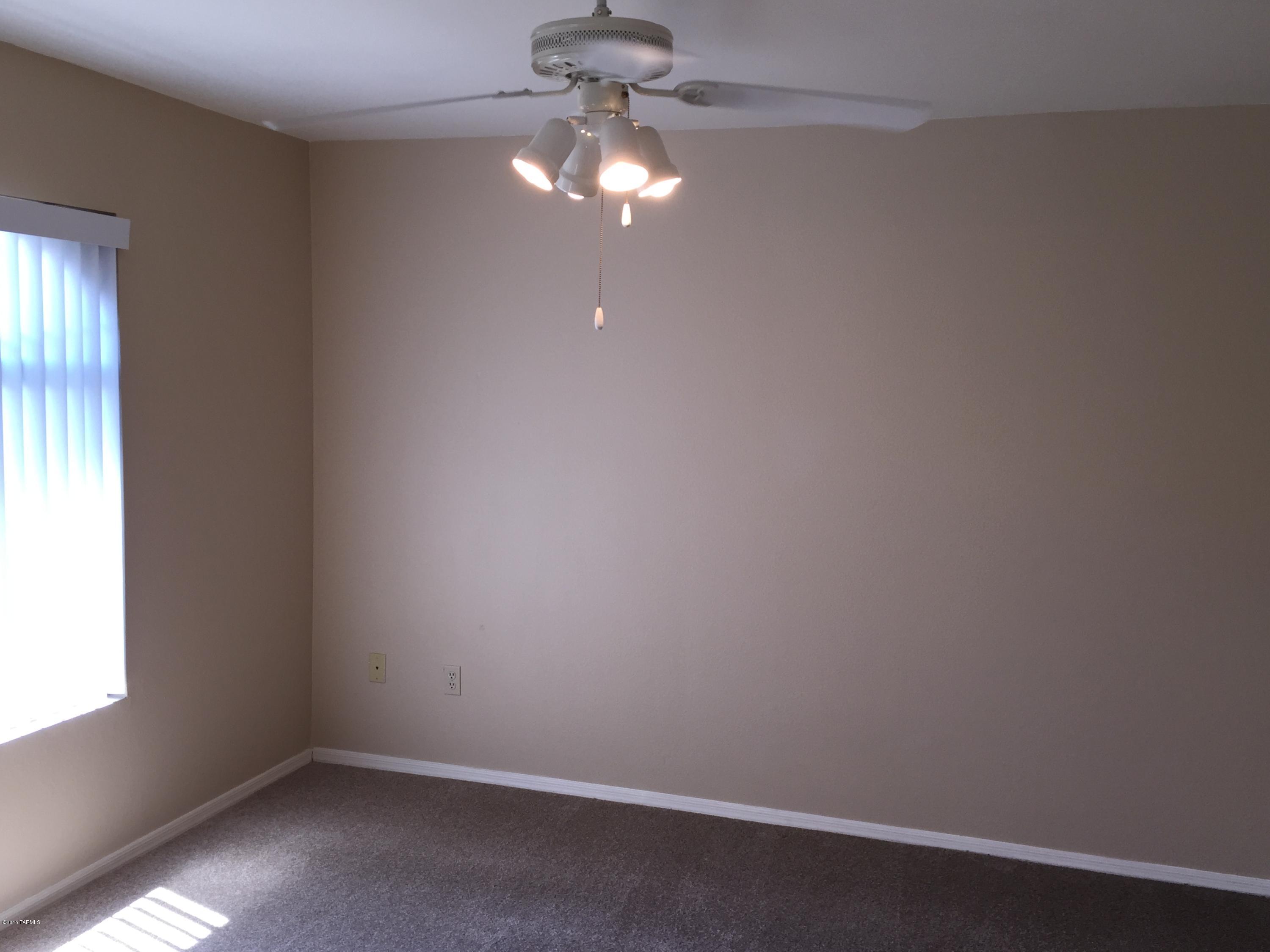 5751 North Kolb Road, Unit 28201 Tucson, AZ 85750 - Photo 11 of 14 an empty room with a window and a fan