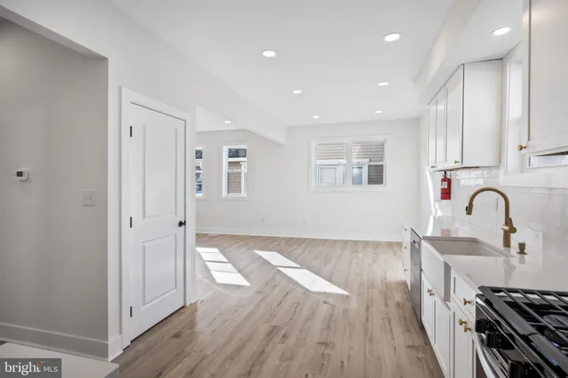 a view of kitchen with wooden floor and electronic appliances