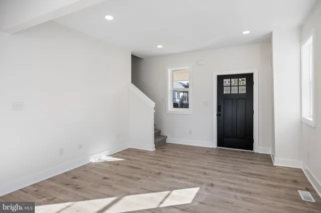 a view of hallway with wooden floor