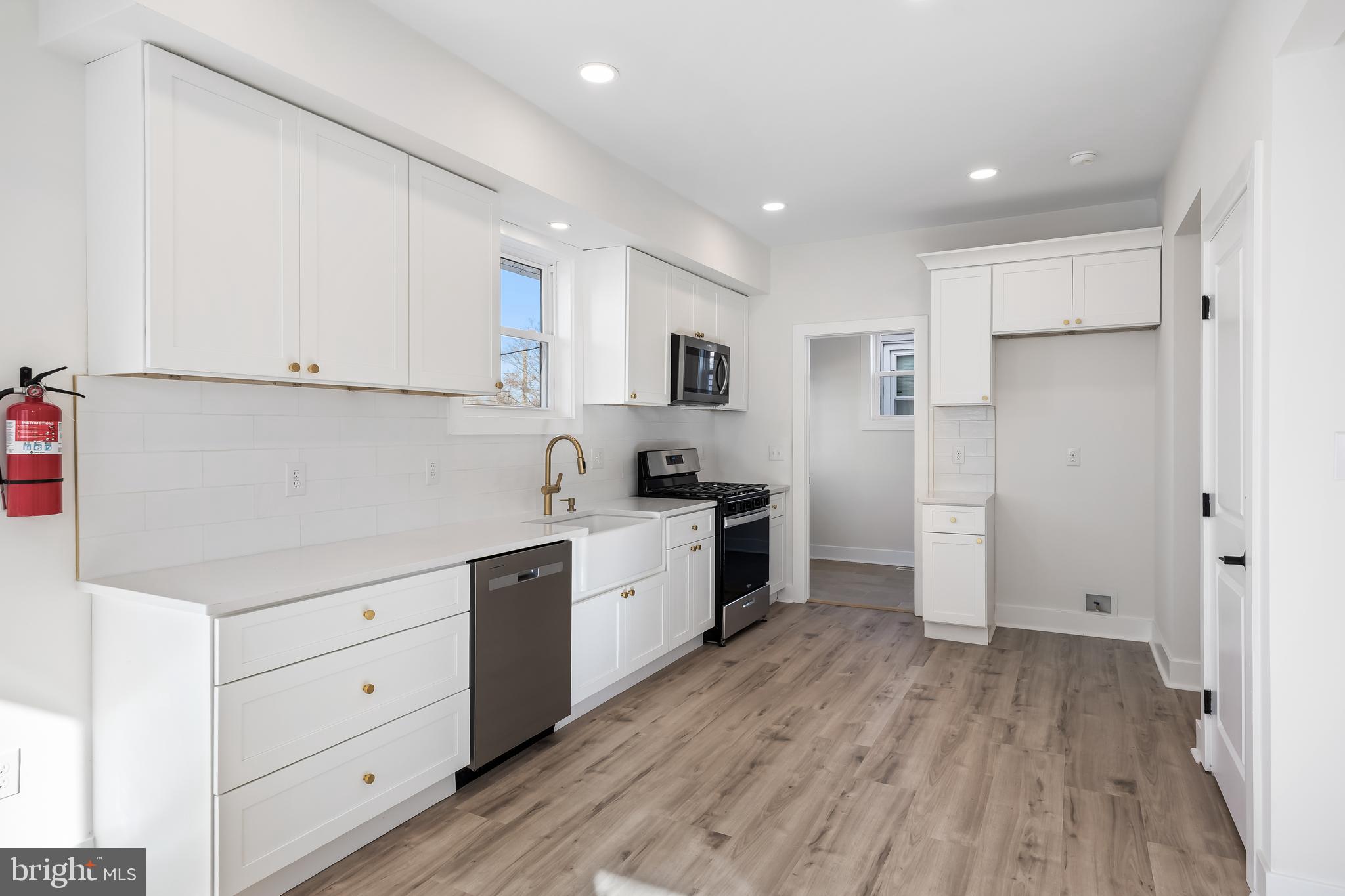 133 Lafayette Road Audubon, NJ 08106 - Photo 8 of 23 a kitchen with white cabinets and white appliances