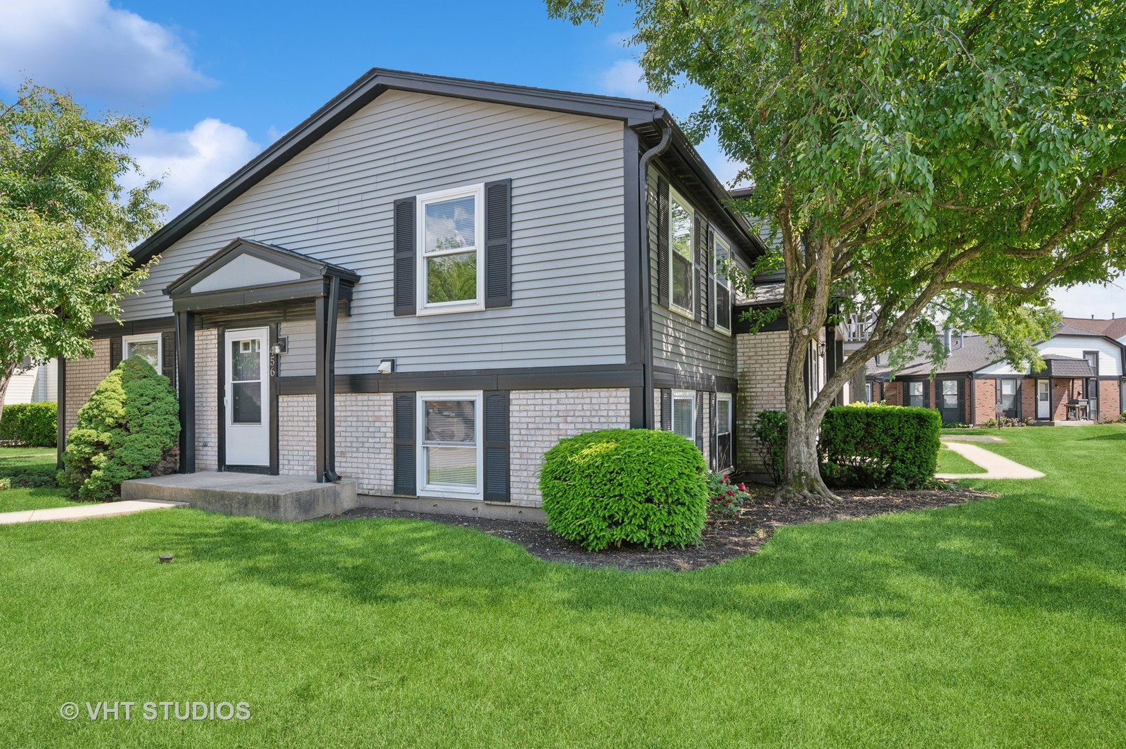 a view of a house with a yard and plants
