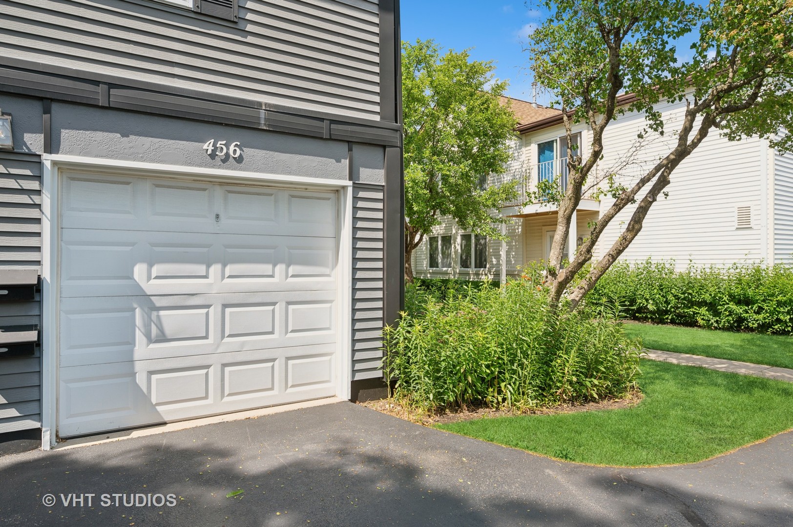 456 Inverrary Lane Deerfield, IL 60015 - Photo 13 of 17 a front view of a house with a garden