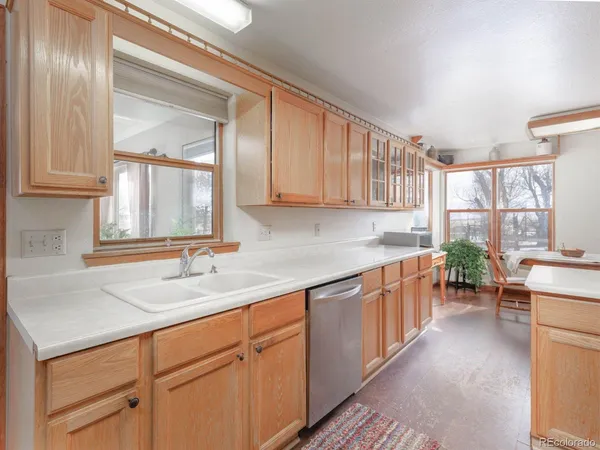 a kitchen with sink cabinets and a window