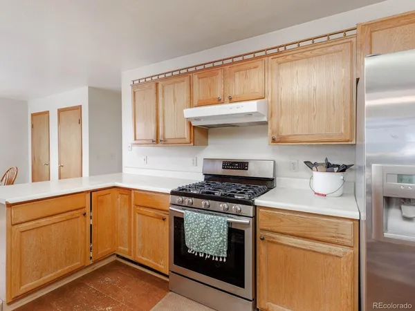 a kitchen with granite countertop a sink stove and cabinets
