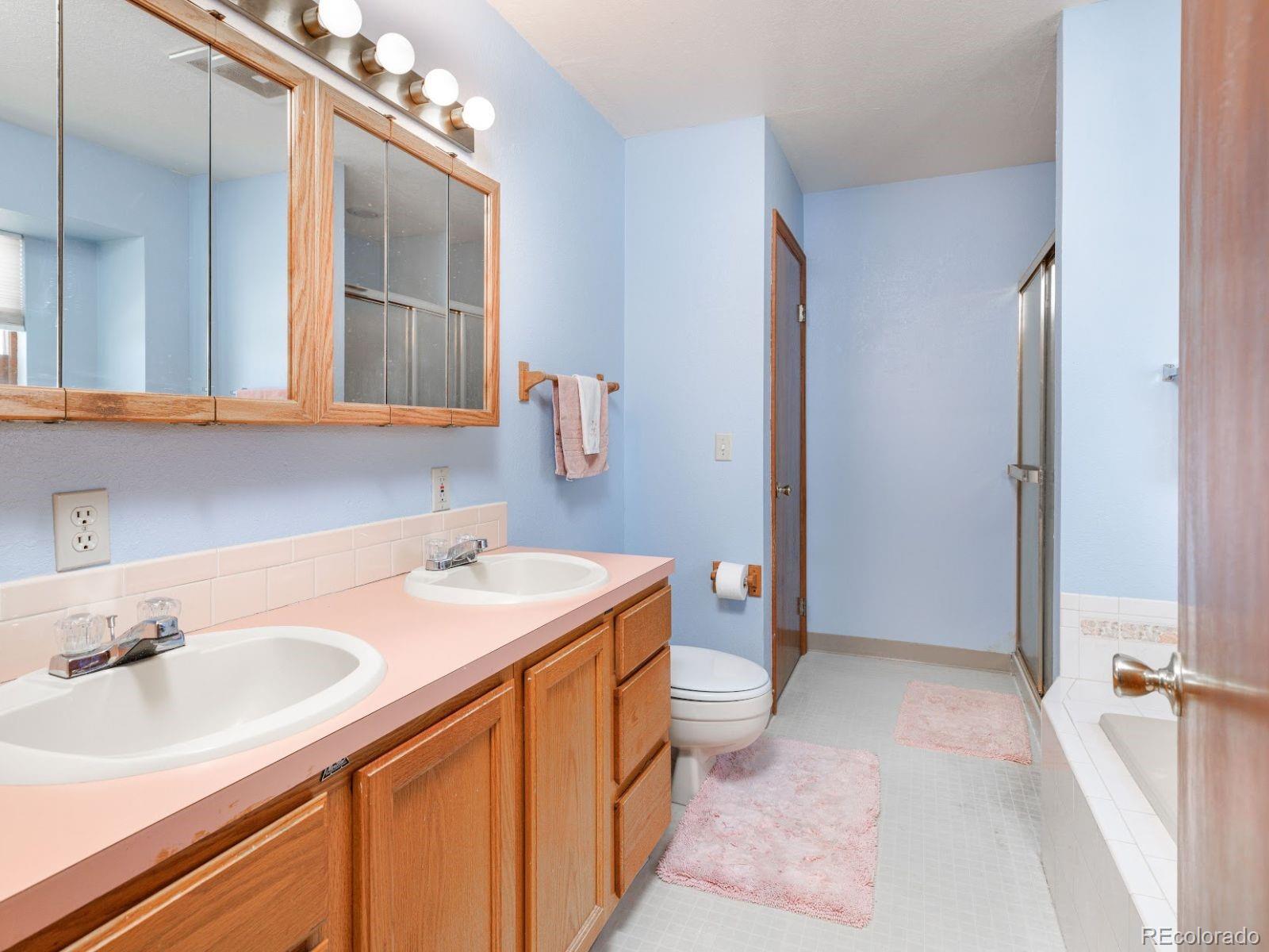 6115 Sengbeil Road Yoder, CO 80864 - Photo 17 of 43 a bathroom with a sink a vanity and a mirror
