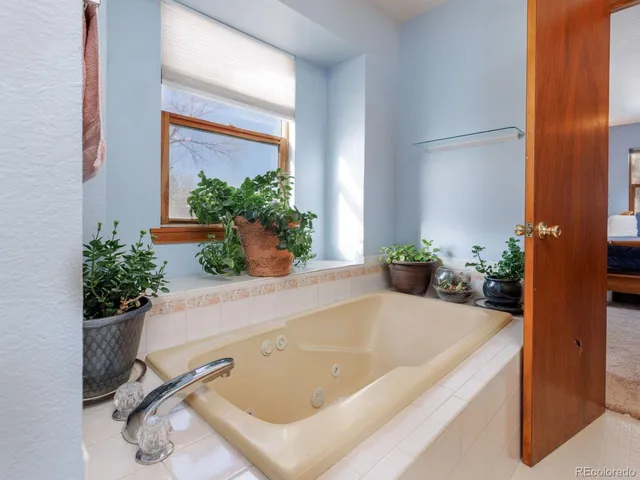 a white bath tub sitting in a bathroom next to a tub