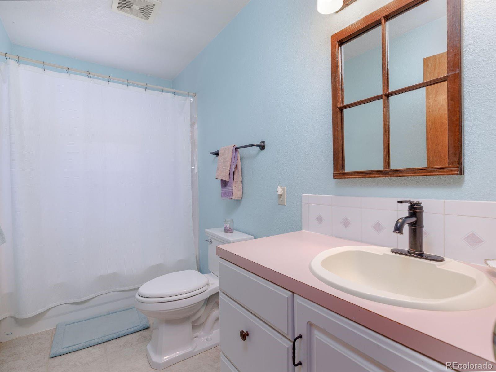 6115 Sengbeil Road Yoder, CO 80864 - Photo 21 of 43 a bathroom with a sink a toilet and mirror