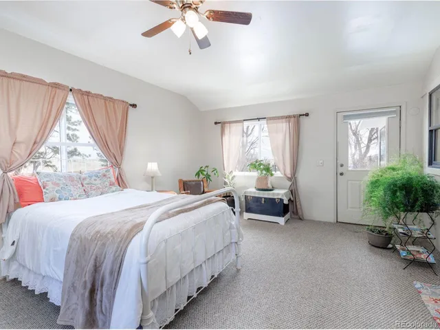 a bedroom with a bed and a couch