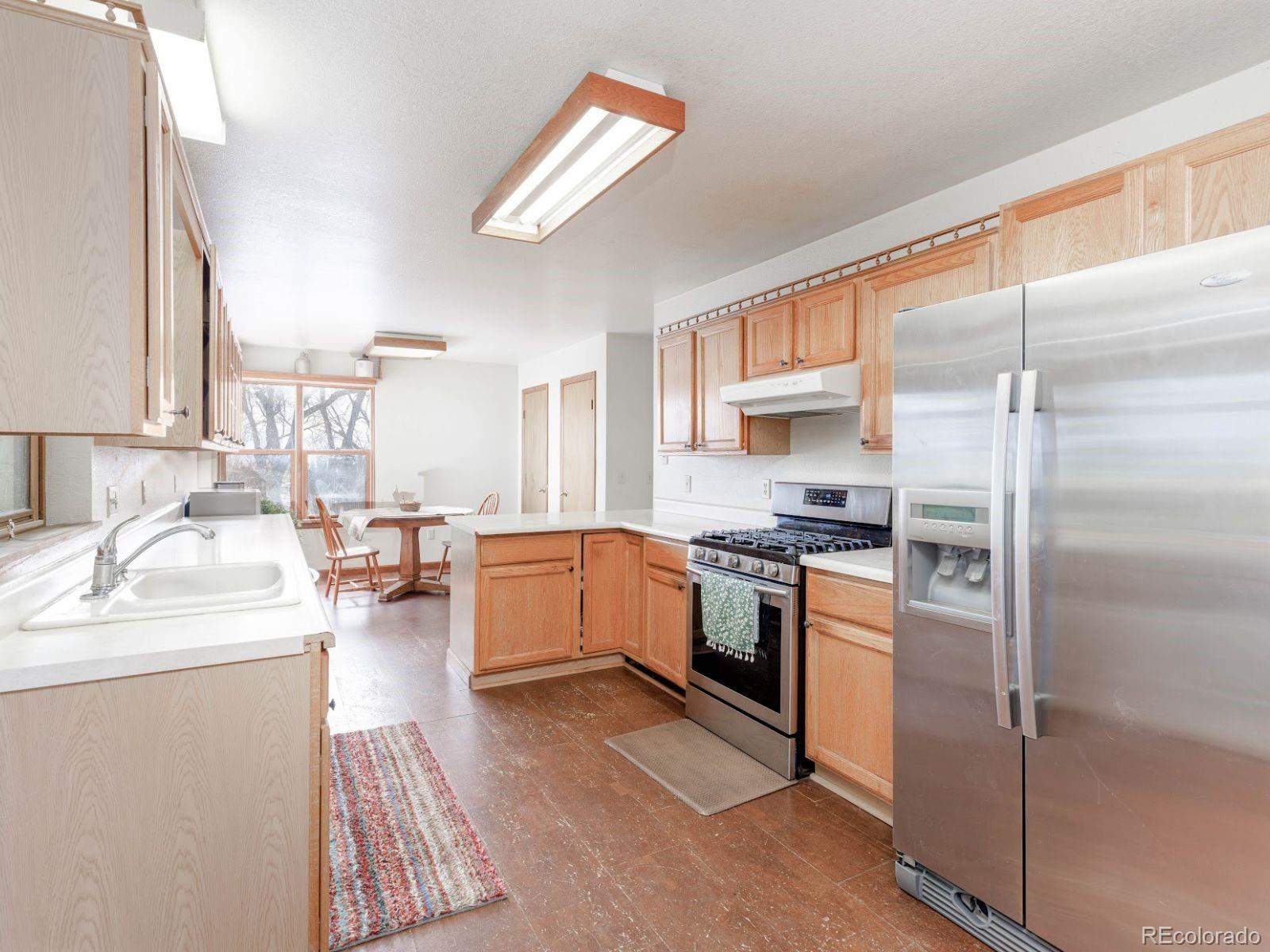 6115 Sengbeil Road Yoder, CO 80864 - Photo 10 of 43 a kitchen with a refrigerator sink and a stove