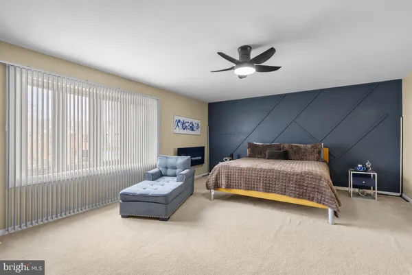 a bedroom with a bed and a couch