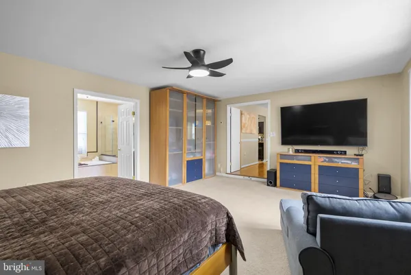 a bedroom with bed and a flat screen tv