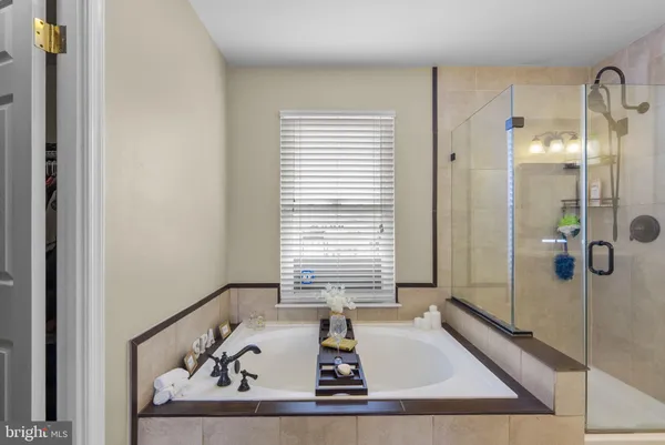 a bathroom with a tub and a shower
