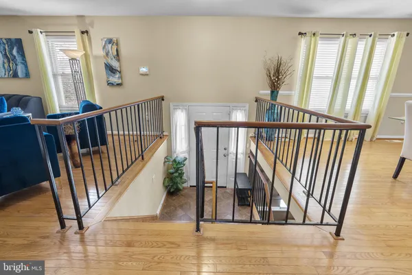 a view of staircase with railing and white walls