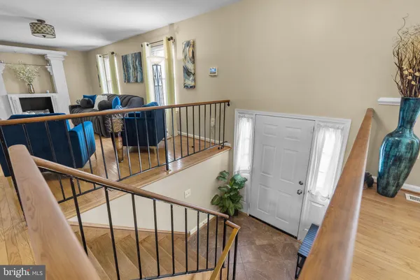 a view of an entryway with hardwood floor and stairs