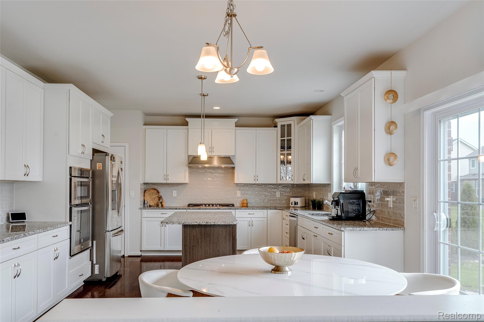 51011 Rockingham Drive Canton, MI 48188 - Photo 17 of 74 Kitchen with white cabinetry, glass insert cabinets, decorative backsplash, and light stone counters
