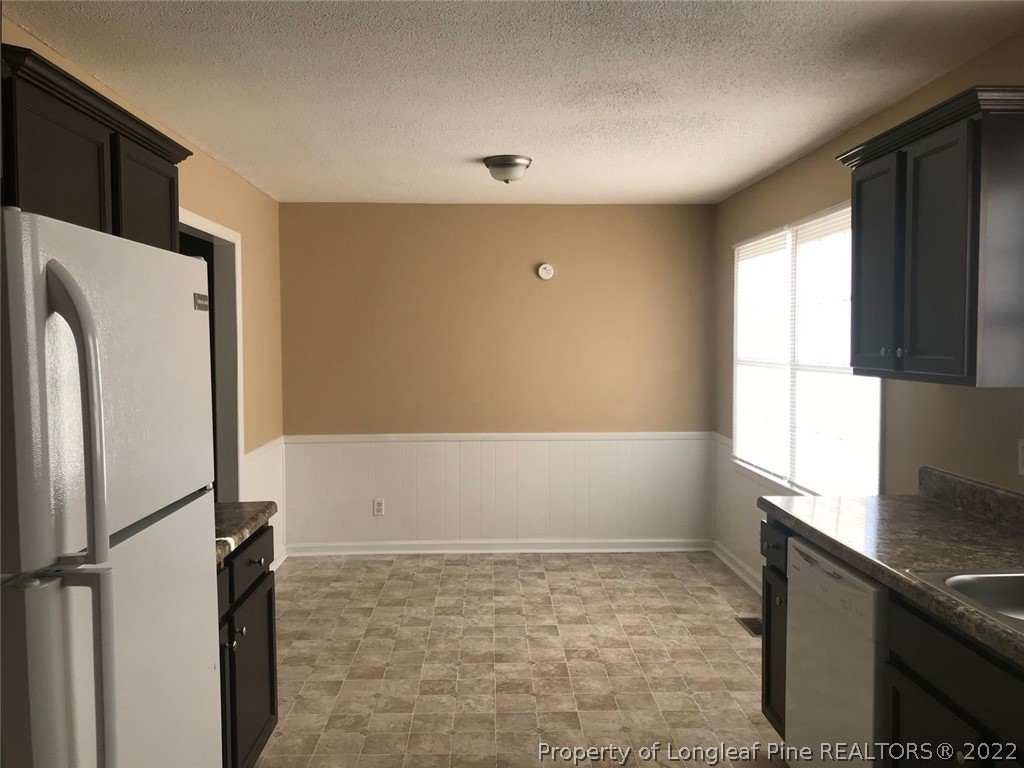 4510 Ruby Road Fayetteville, NC 28311 - Photo 5 of 22 a view of a kitchen with a sink and a refrigerator