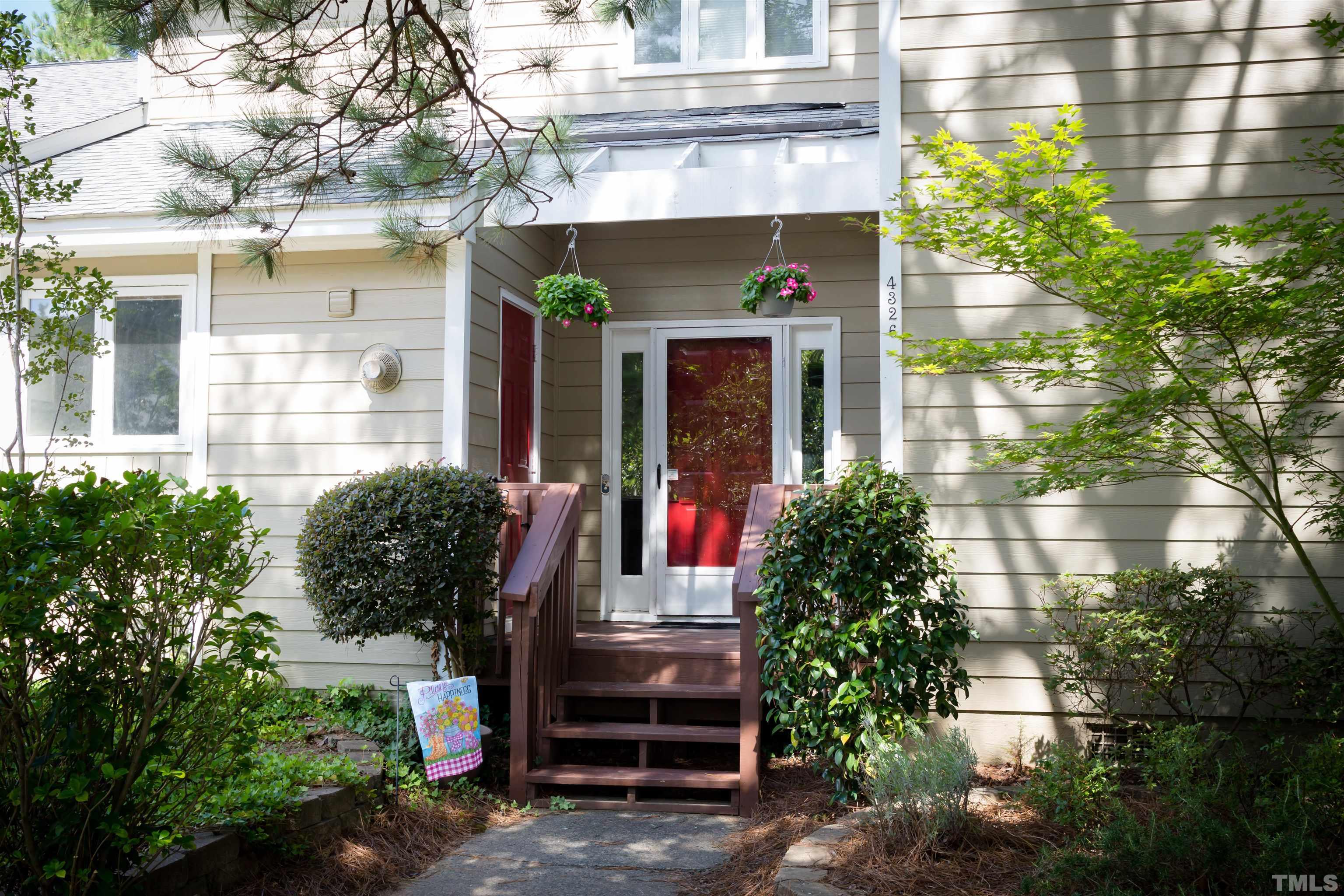 a front view of a house with a garden