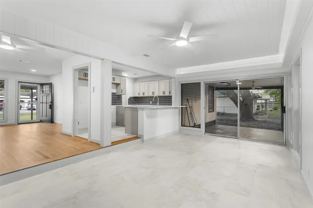 a view of a livingroom with kitchen and chandelier