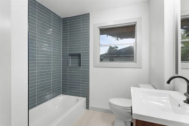 a bathroom with a toilet and a tub