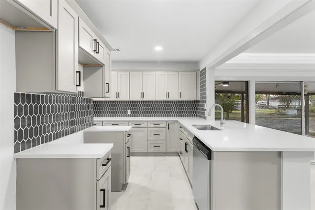 a kitchen with a sink stove and cabinets