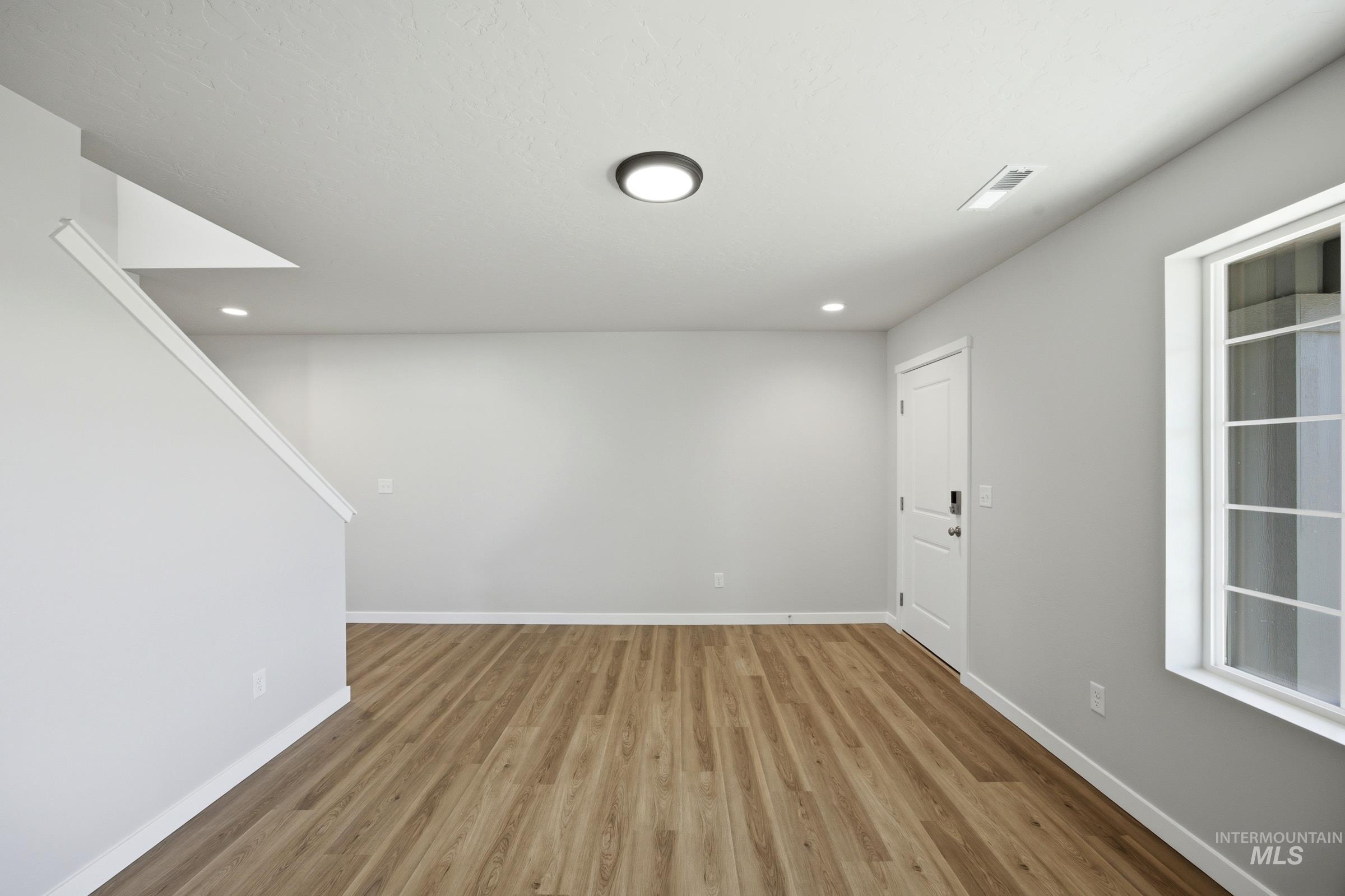 13333 Bank Street Caldwell, ID 83607 - Photo 4 of 29 Wood-finish flooring, recessed lighting, and a contemporary ceiling fixture