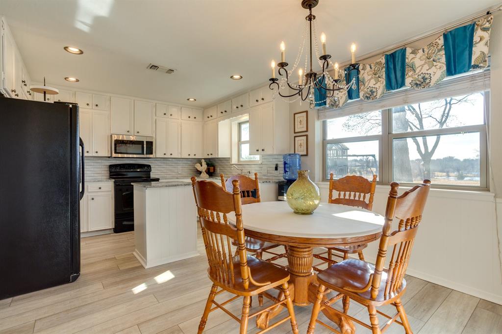 477 Fm 1553 Bonham, TX 75418 - Photo 4 of 10 a view of a dining room and livingroom with furniture wooden floor a chandelier