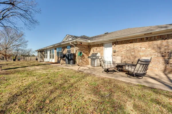 a view of a house with backyard porch and sitting area