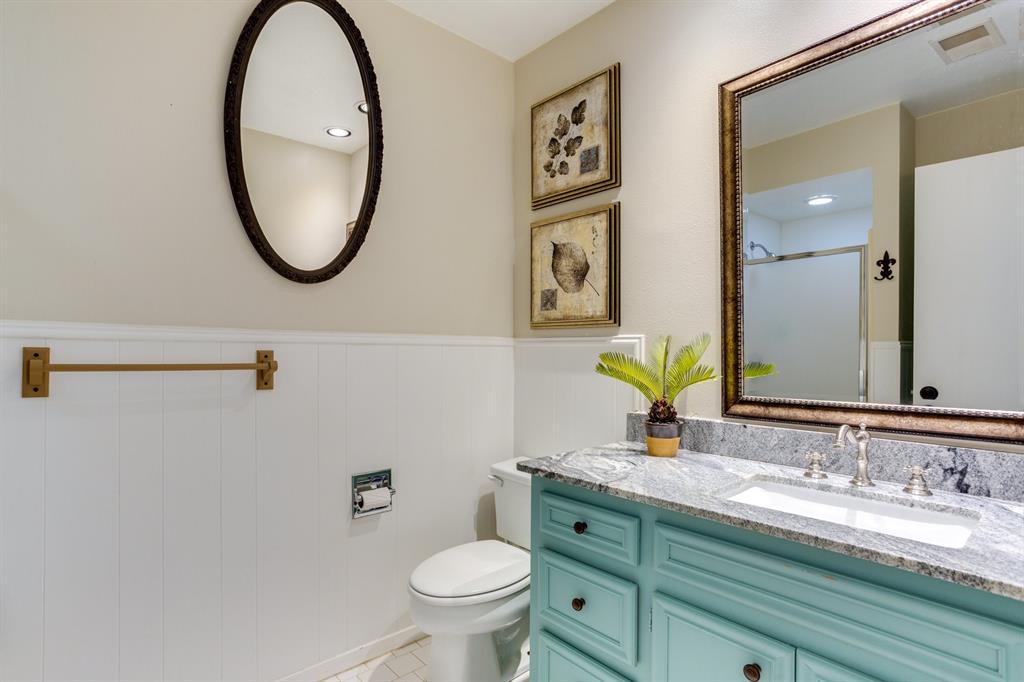 477 Fm 1553 Bonham, TX 75418 - Photo 5 of 10 a bathroom with a granite countertop toilet a sink and a mirror