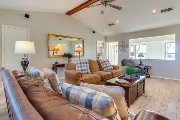 a living room with furniture and a lamp