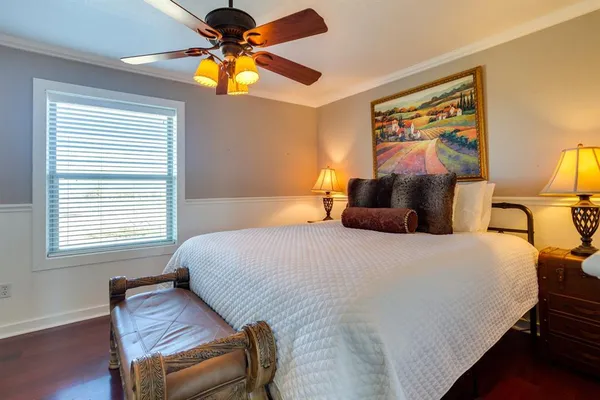 a bedroom with a bed and a chandelier