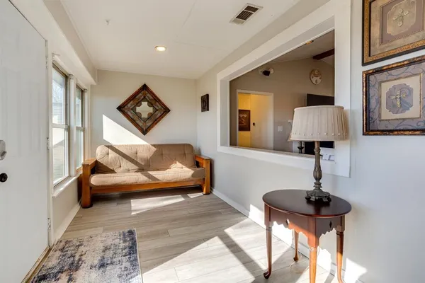 a living room with furniture and a lamp