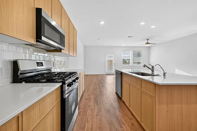a kitchen with a sink and refrigerator