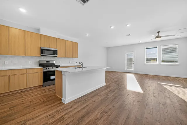 a view of kitchen with furniture and wooden floor