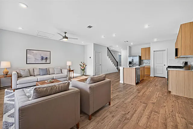 a kitchen with stainless steel appliances granite countertop a sink a stove top oven a counter space and cabinets