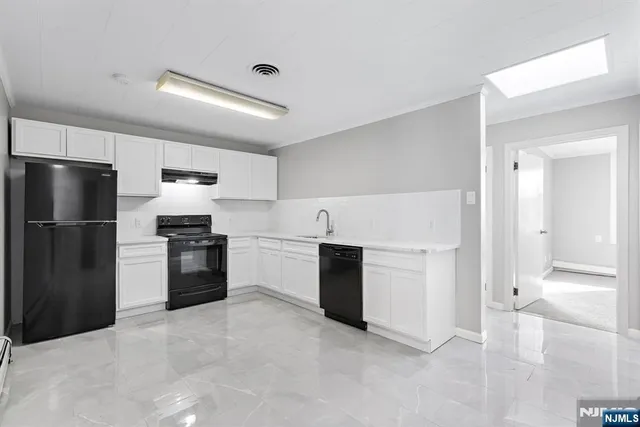 a kitchen with a refrigerator and a stove