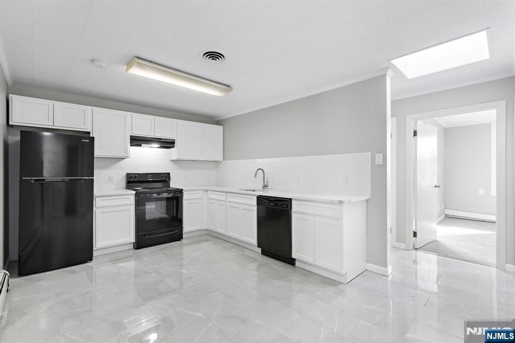 a kitchen with a refrigerator and a stove