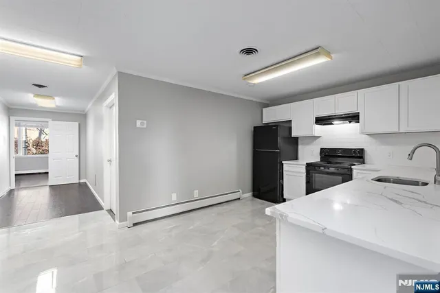 a kitchen with refrigerator and cabinets