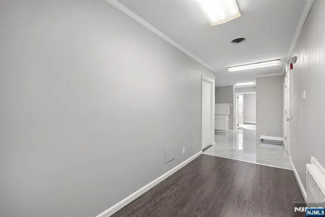 a view of an empty room and wooden floor