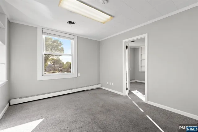 an empty room with windows and closet