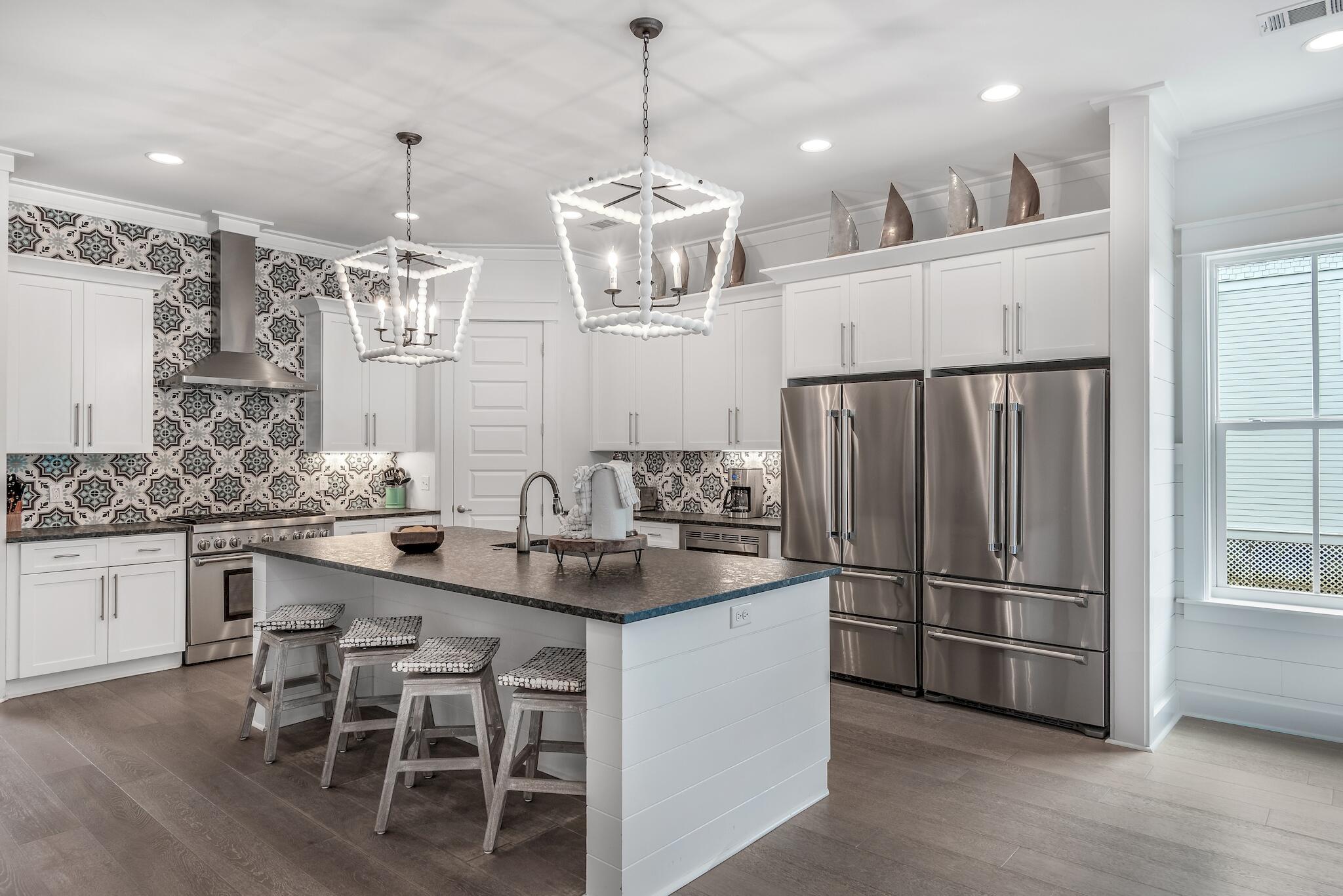 101 A St Inlet Beach Inlet Beach, FL 32461 - Photo 3 of 49 a kitchen with stainless steel appliances granite countertop a refrigerator a sink dishwasher a dining table and chairs with wooden floor