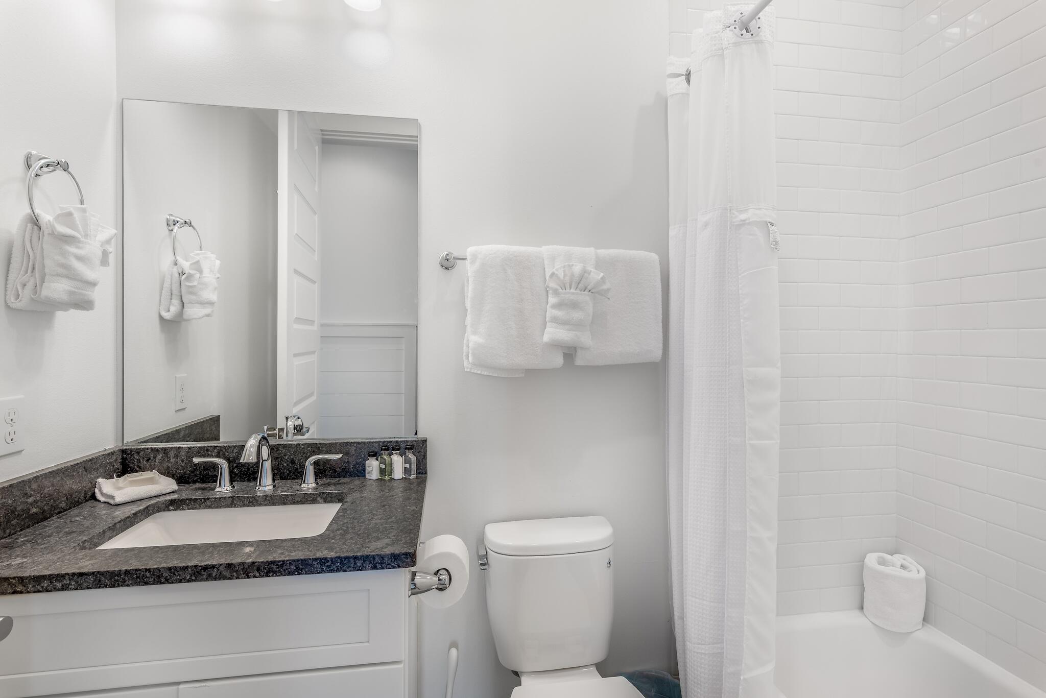 101 A St Inlet Beach Inlet Beach, FL 32461 - Photo 49 of 49 a bathroom with a granite countertop sink a toilet and a mirror